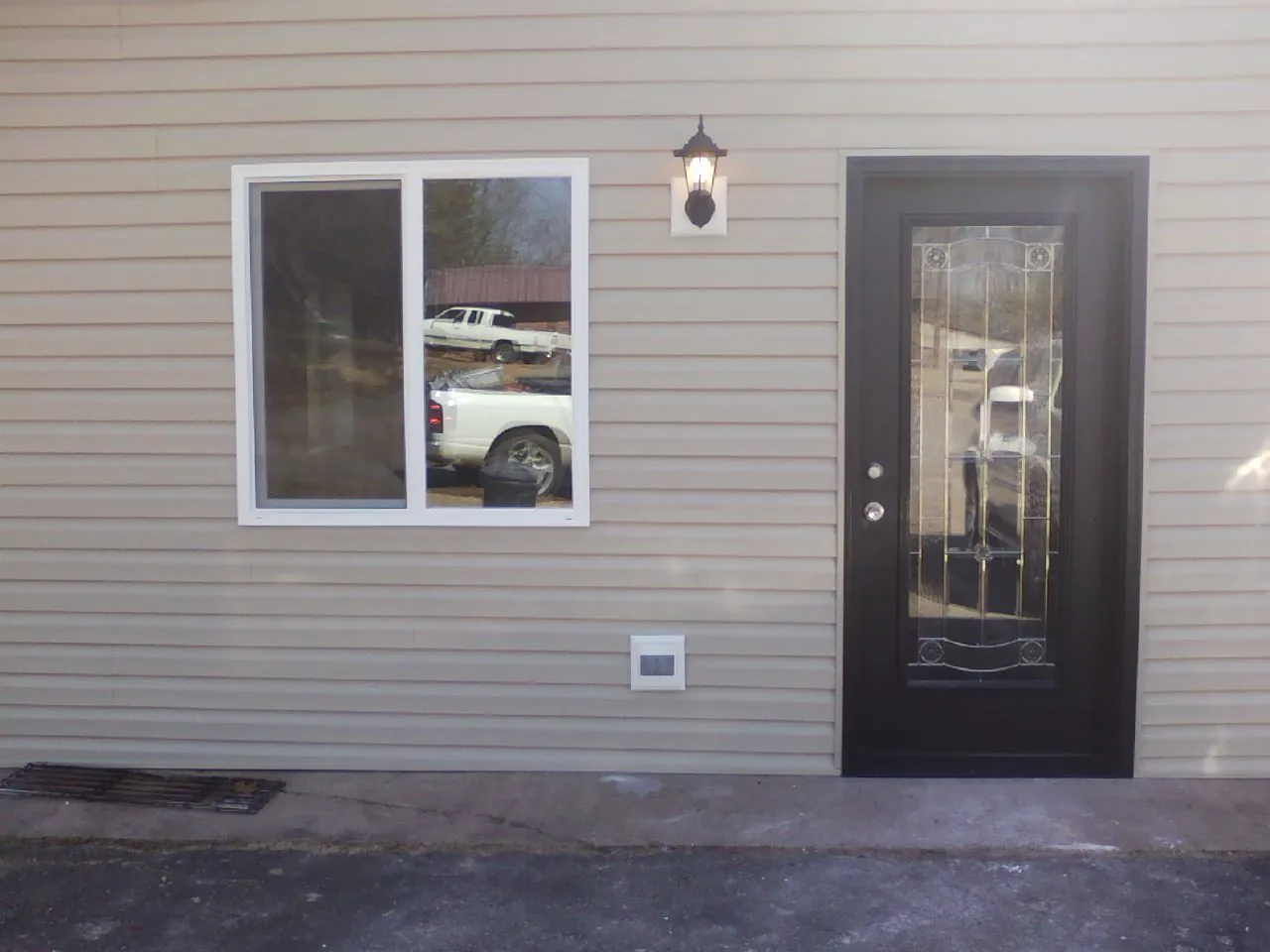 New siding, window and entry door on the side of an addition in Zillah